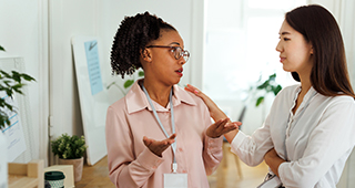 two women talking at the office